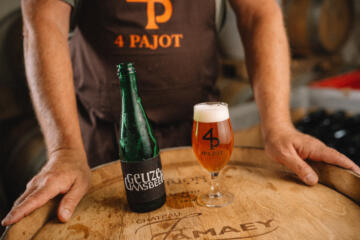 Fles en vol glas geuze van brouwerij 4 Pajot op een ton